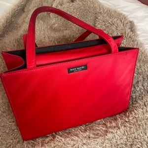 Red Kate Spades hand bag, good condition with minor stains that can be washed.